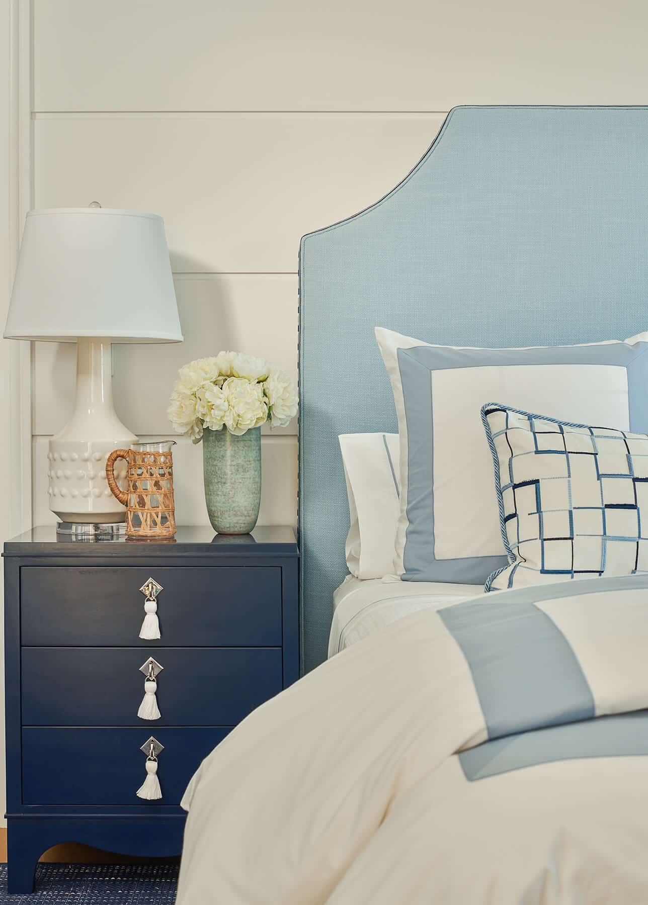 Nantucket, bedroom with light blue headboard and dark blue side table